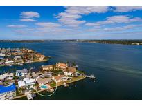 Aerial view of waterfront community featuring private docks, pools, and stunning water access at 825 116Th Ave, Treasure Island, FL 33706