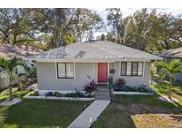 Gray house with red door, landscaping, and walkway at 946 23Rd S Ave, St Petersburg, FL 33705