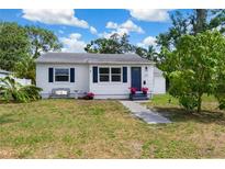 Charming single-story home with well-maintained lawn, walkway, and colorful flower accents at 215 35Th Ne Ave, St Petersburg, FL 33704