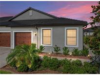 Well-maintained house with a two-car garage and landscaped front yard at 31500 Magna Gulf Loop, San Antonio, FL 33576