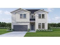 Two-story house with gray siding, dark gray garage door, and landscaping at 446 Rotary Ne Pl, St Petersburg, FL 33703
