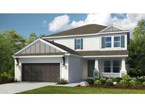 Two-story home with gray siding, brown garage door, and landscaping at 5134 Slate Hue Pl, Apollo Beach, FL 33572