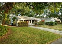 Charming single-story home with a lush green lawn and mature trees offering ample shade at 637 Jamaica Ave, Tampa, FL 33606