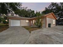 Newly renovated home with a brick facade, white garage door, and landscaped yard at 503 Avocado Cir, Brandon, FL 33510