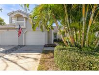 Two-car garage, landscaped yard, and attractive exterior at 2458 Alhambra St, Clearwater, FL 33761