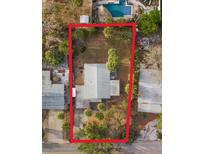 Aerial view of a single-Gathering home with a pool and surrounding landscape at 3863 Belle Vista E Dr, St Pete Beach, FL 33706