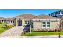 Beautiful single-story home with a brick driveway, neutral colored exterior, and well-maintained landscaping at 3901 Tour Trce, Land O Lakes, FL 34638