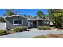 Charming single-story home featuring a gray exterior, well-maintained landscaping, and a cozy front entrance at 4659 Helena Ne St, St Petersburg, FL 33703