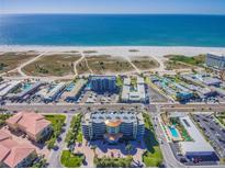 Aerial view of beachfront property, showcasing the building and surrounding beach at 11605 Gulf Blvd # 507, Treasure Island, FL 33706