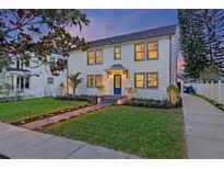 Two-story craftsman home with a charming front porch and well-manicured lawn at 2410 Woodlawn E Cir, St Petersburg, FL 33704