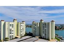 Aerial view of waterfront condo building with parking and boat slips at 400 64 Ave # 1207, St Pete Beach, FL 33706