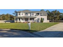 Two-story house with a large yard, driveway, and mailbox at 11305 Sweet Bay Ct, Riverview, FL 33569