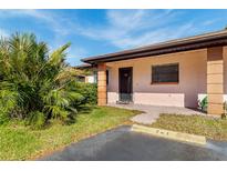 Exterior view of condo with parking and landscaping at 13250 Ridge Rd # 2-1, Largo, FL 33778
