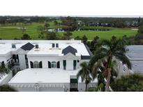 Aerial view of home showcasing the building's exterior, landscaping, and golf course location at 921 Osceola Rd, Belleair, FL 33756