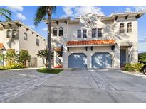 Elegant two-story home with a two-car garage, featuring a well-manicured lawn and lovely tropical landscaping at 102 S Moody Ave # 3, Tampa, FL 33609