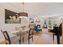 Bright dining area with glass table and view to living room at 1688 Watermark Ne Cir, St Petersburg, FL 33702