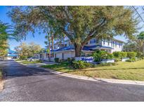 Watermark community featuring townhouses with blue roofs and lush landscaping at 1688 Watermark Ne Cir, St Petersburg, FL 33702