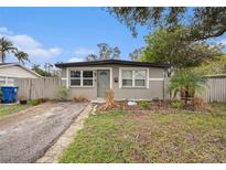 Updated single-story home with a gray exterior and small front yard at 1866 Oregon Ne Ave, St Petersburg, FL 33703