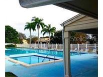A beautiful community pool offers a relaxing space, complete with palm trees and plenty of space to lounge at 6262 93Rd N Ter # 3904, Pinellas Park, FL 33782