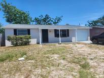 Charming single-story home featuring a welcoming front porch, attached garage and freshly painted exterior at 11608 Zimmerman Rd, Port Richey, FL 34668