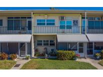 Cozy two-story condo with a well-manicured lawn and inviting front entrance at 4001 58Th N St # 20, Kenneth City, FL 33709