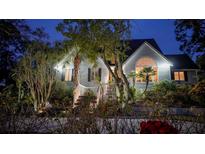 Two-story house with landscaped yard, large windows, and a welcoming front porch at 9034 Baywood Park Dr, Seminole, FL 33777