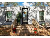 Modern container home exterior with wood deck and landscaping at 5021 69Th N Way, St Petersburg, FL 33709