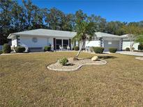 Single-story home with attractive landscaping and a two-car garage at 1707 New Bedford Dr, Sun City Center, FL 33573