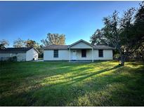 One-story house with a spacious lawn and detached garage at 2525 Turkey Creek Rd, Plant City, FL 33566