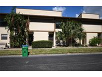 Front view of a townhouse with landscaping and a paved driveway at 9209 Seminole Blvd # 67, Seminole, FL 33772