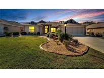 Beautiful home with landscaped lawn, attractive curb appeal, and a two-car garage at 334 Caloosa Palms Ct, Sun City Center, FL 33573