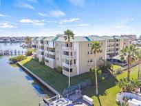 Stunning waterfront condo with lush landscaping, boat slips, and convenient covered parking at 399 150Th Ave # A203, Madeira Beach, FL 33708