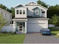 Two-story home with gray siding, blue accents, and a two-car garage at 3801 71St N St, St Petersburg, FL 33709