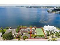 Aerial view of waterfront property with pool and tennis court at 5029 W San Miguel St, Tampa, FL 33629
