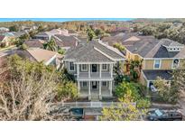 Two-story house with a balcony and white picket fence, nicely landscaped at 10130 Balcony St, New Port Richey, FL 34655