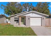 Updated one-story home with attached garage and landscaped lawn at 1867 Nevada Ne Ave, St Petersburg, FL 33703