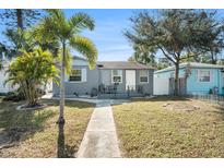 Gray brick house with a landscaped yard, walkway, and a small porch at 3510 1St S Ave, St Petersburg, FL 33711