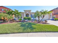 Single-story home with landscaped lawn and two-car garage at 13230 Fawn Lily Dr, Riverview, FL 33579