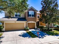Two-story townhome with attached garage and driveway, located on a tree-lined street at 4904 Barnstead Dr, Riverview, FL 33578