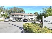Heather Lake Condominiums building with parking and landscaping at 930 Virginia St # 201, Dunedin, FL 34698