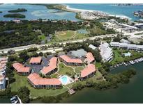 Aerial view of waterfront community with pool, tennis courts, and boat slips at 1515 Pinellas Bayway S # 35, Tierra Verde, FL 33715