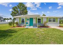 Charming single story home with teal door and green shutters at 4021 Eagle Nest Dr, Hernando Beach, FL 34607