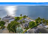 Aerial view of waterfront home with pool and private dock at 5033 W San Miguel St, Tampa, FL 33629