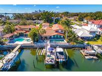 Aerial view of waterfront home with private dock, pool, and boat slips at 747 Brightwaters Ne Blvd, St Petersburg, FL 33704