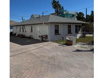 White single story home with paved driveway and mature landscaping at 102 87Th Ave, Treasure Island, FL 33706