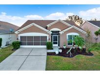 Attractive single-story home with a two-car garage and landscaped front yard at 12612 Midpointe Dr, Riverview, FL 33579