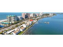 Aerial view of beachfront property with ocean, beach, and high-rise buildings at 1390 Gulf Blvd # 302, Clearwater Beach, FL 33767