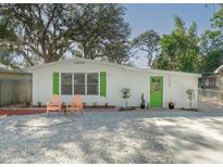 Charming single story home with a green door and landscaped yard at 1428 Illinois Ave, Palm Harbor, FL 34683
