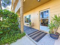 Inviting condo front patio with seating and lush landscaping at 2467 Finlandia Ln # 9, Clearwater, FL 33763