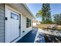 Inviting front entry with white door and decorative glass accents at 3562 Fisher Rd, Palm Harbor, FL 34683